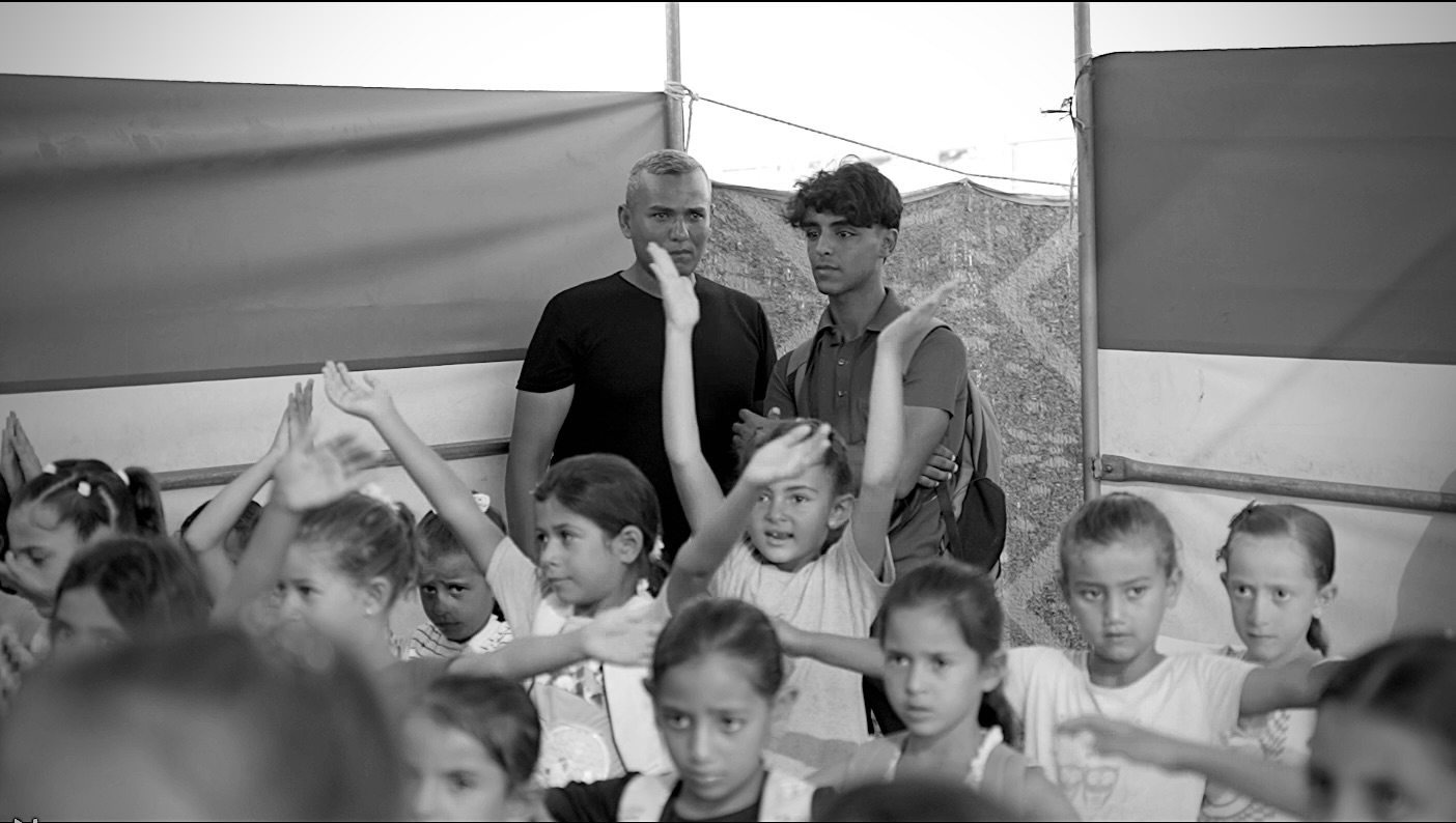 A crowd of children with raised hands