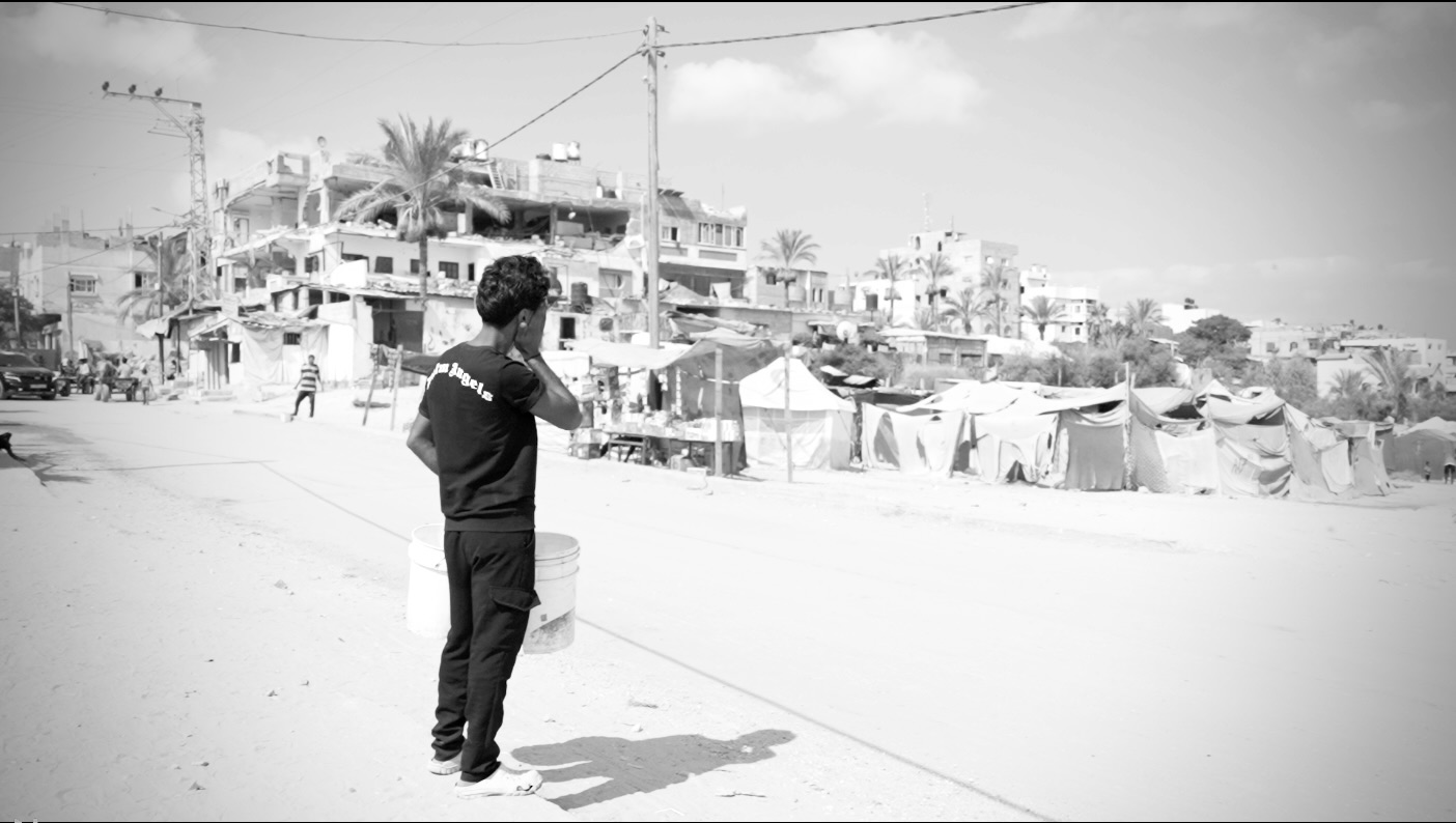 A boy facing the camp